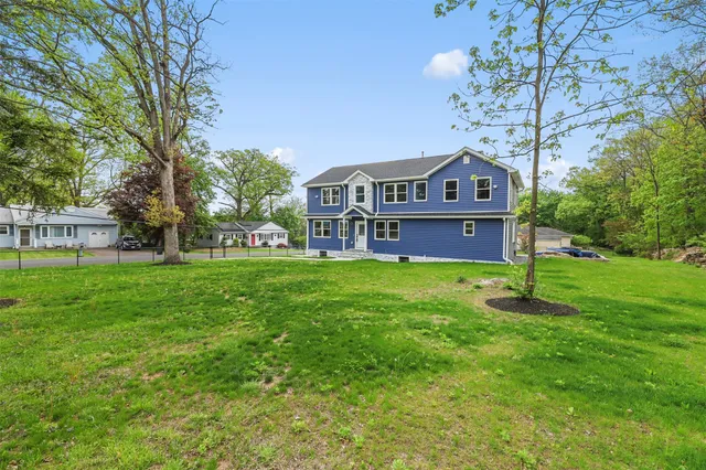 a front view of a house with a yard table and chairs