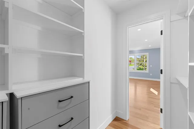 a view of hallway with wooden floor