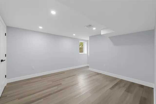 a view of room with wooden floor and window