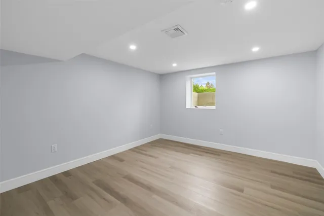 a view of room with wooden floor and window