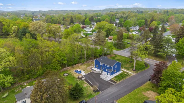 an aerial view of a house with a yard