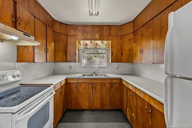 a kitchen with a sink stove and cabinets