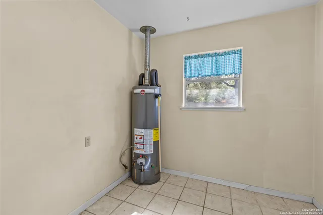 a view of a storage & utility room with a window
