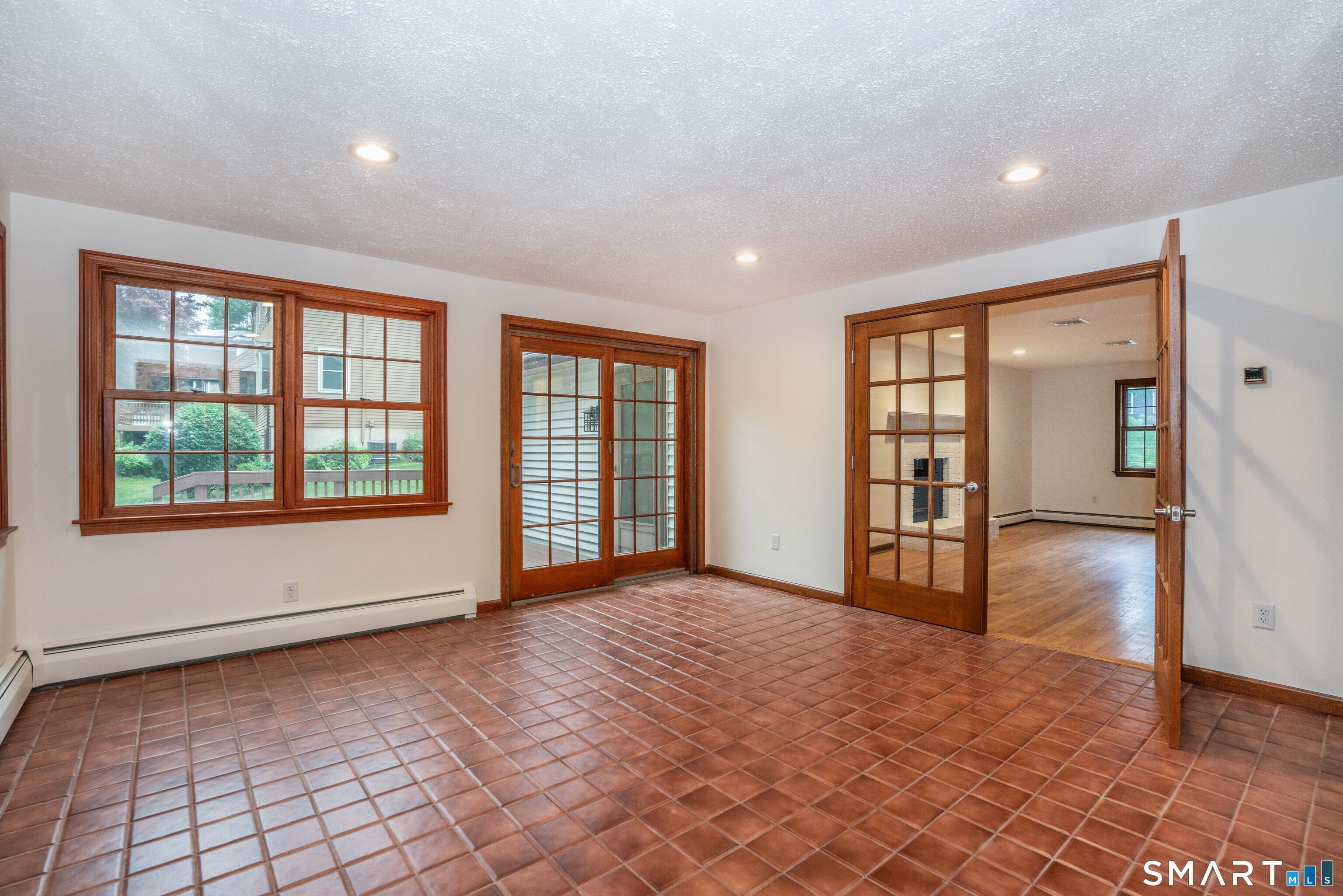182 Valley View Road Manchester, CT 06040 - Photo 22 of 40 View of Sun Room toward Family Room and slider to deck