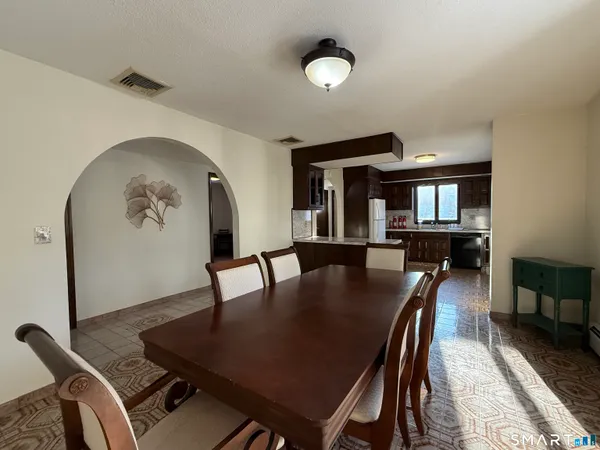 a dining room with furniture and window