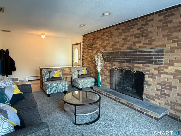 a living room with furniture and a fireplace