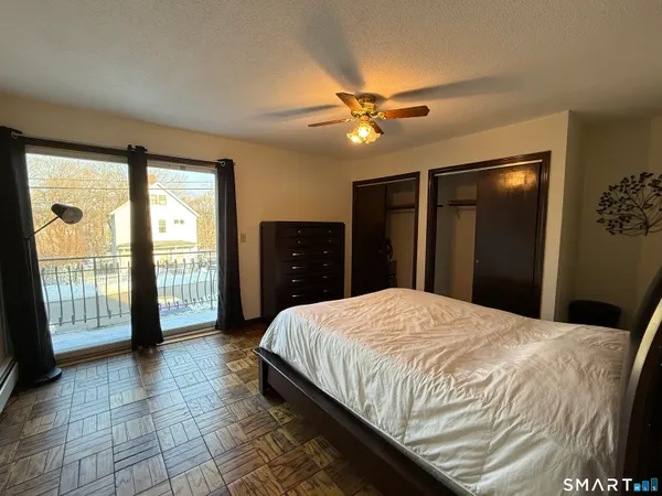 a bedroom with a bed and a large window