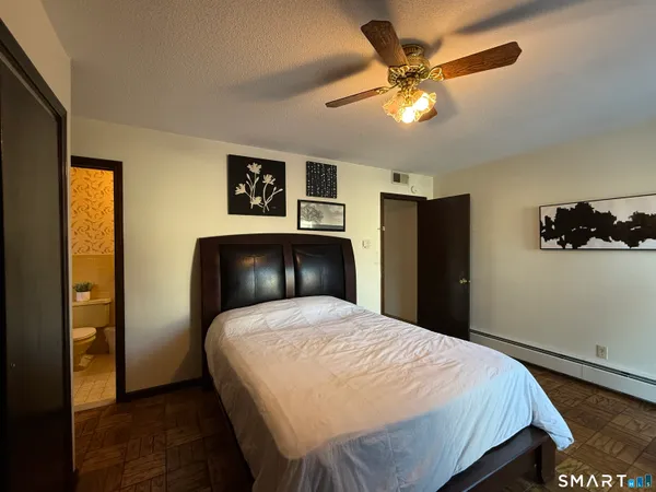 a bedroom with a bed and a chandelier