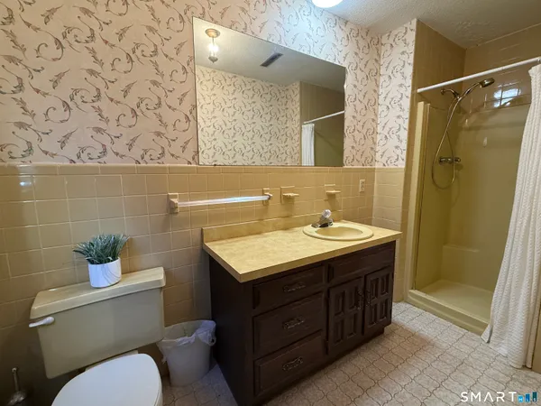 a bathroom with a sink toilet and shower