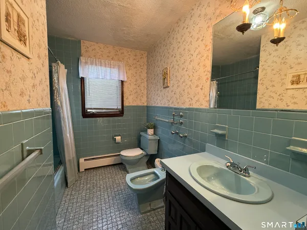 a bathroom with a sink toilet and mirror