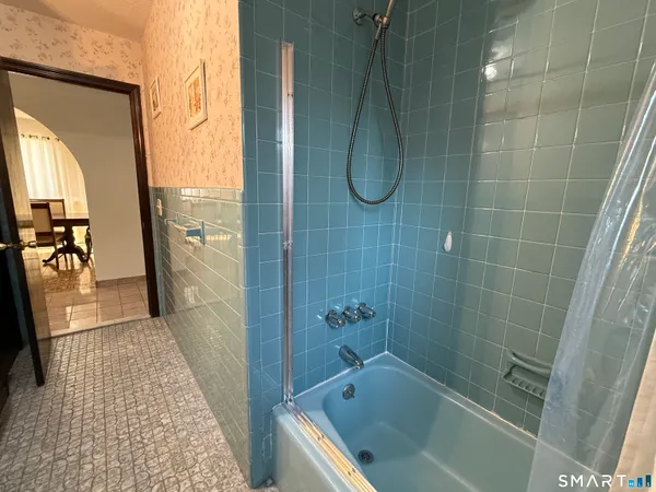 a bathroom with a shower and a sink