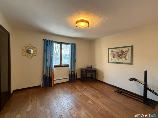 a view of room with window and wooden floor