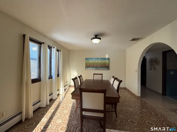 a dining room with furniture and window