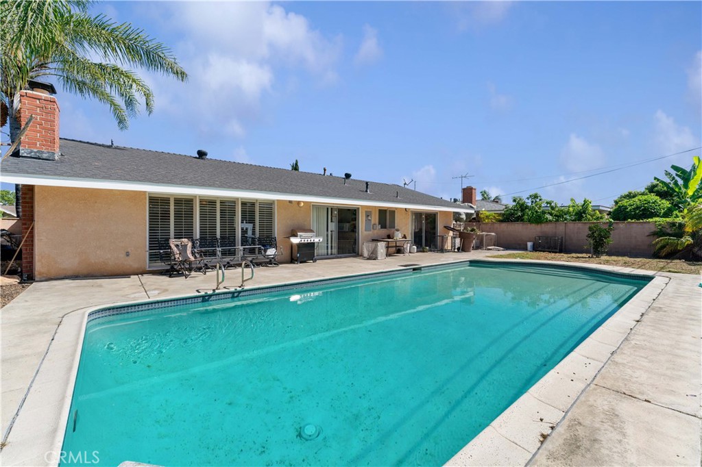 a view of a patio with swimming pool table and chairs