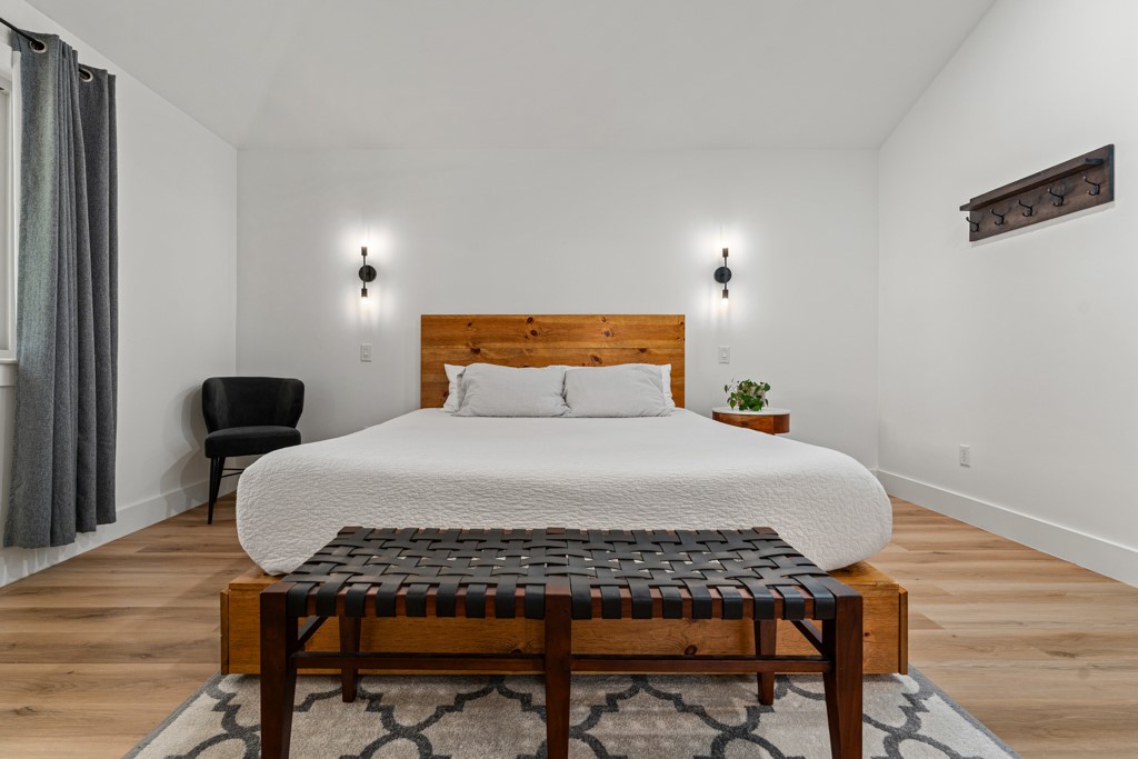 1502 Quail Run Road Pflugerville, TX 78660 - Photo 12 of 37 A generously proportioned bedroom with warm wooden flooring and abundant natural light.