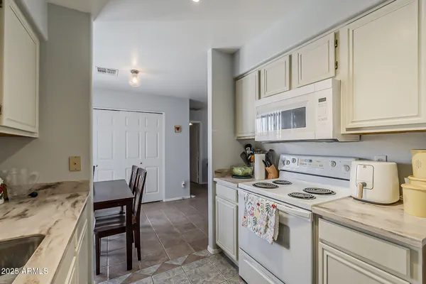 a kitchen with sink and cabinets