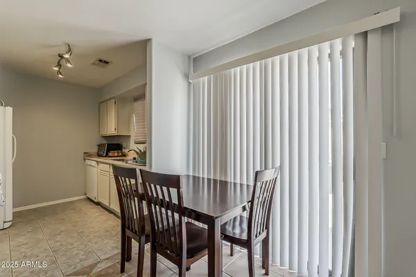 a kitchen with a stove a sink and white cabinets