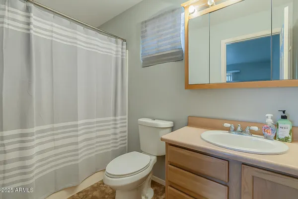 a bedroom with a bed and a chair