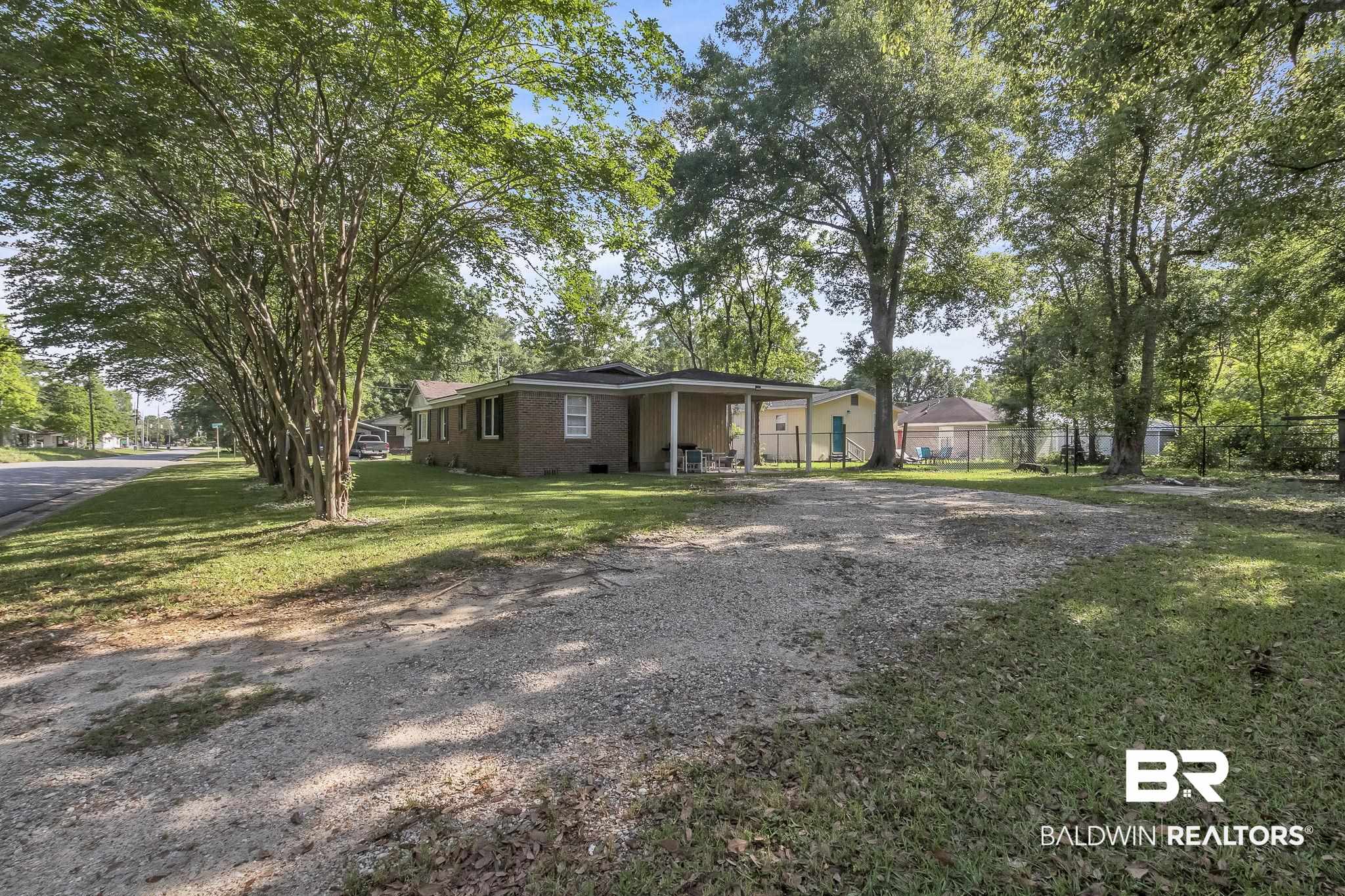 315 Fourth Avenue Chickasaw, AL 36611 - Photo 12 of 28 View of front of property with a front lawn, fence, driveway, and crawl space