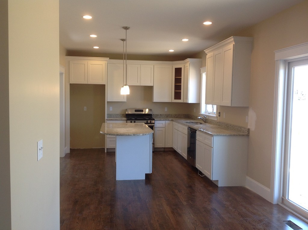 160 Edgell Road Framingham, MA 01701 - Photo 3 of 10 a kitchen with a refrigerator and a stove top oven