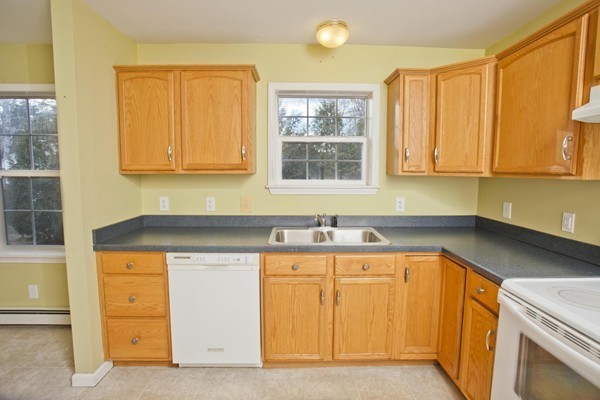 408 Bridge Road, Unit B Northampton, MA 01062 - Photo 4 of 22 a kitchen with a sink a stove and cabinets