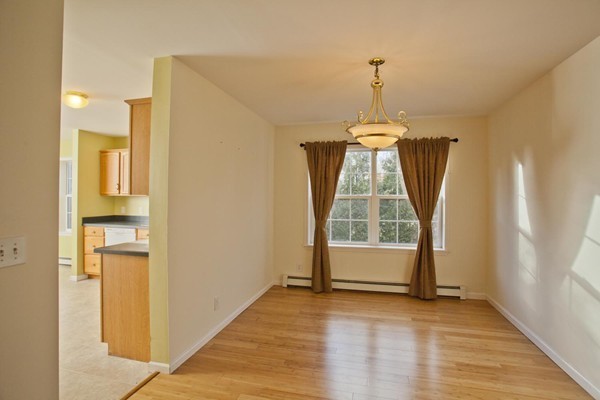 408 Bridge Road, Unit B Northampton, MA 01062 - Photo 6 of 22 a view of empty room with wooden floor and fan