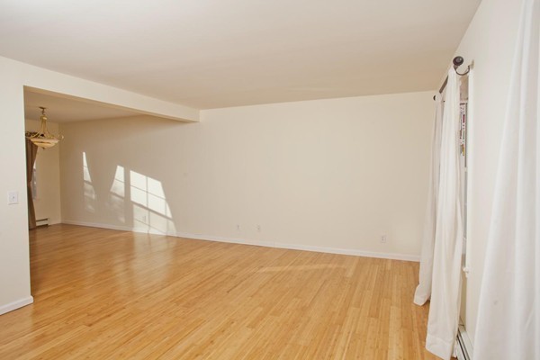 408 Bridge Road, Unit B Northampton, MA 01062 - Photo 9 of 22 a view of an empty room with wooden floor