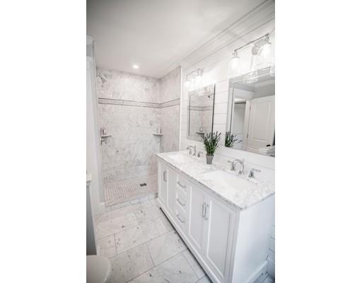 25 Lawton Road Needham, MA 02492 - Photo 23 of 34 a bathroom with a double vanity sink and mirror
