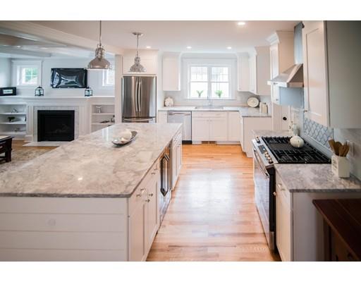 25 Lawton Road Needham, MA 02492 - Photo 7 of 34 a kitchen with kitchen island granite countertop a stove and a sink