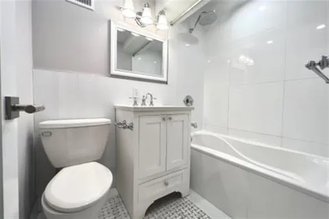 a bathroom with a toilet a sink and bathtub