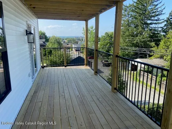a view of a balcony with wooden floor