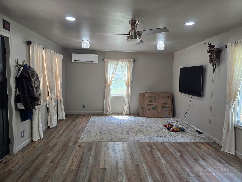 325 Sawyers Road Warrensville, NC 28693 - Photo 24 of 39 a view of a livingroom with wooden floor and a flat screen tv