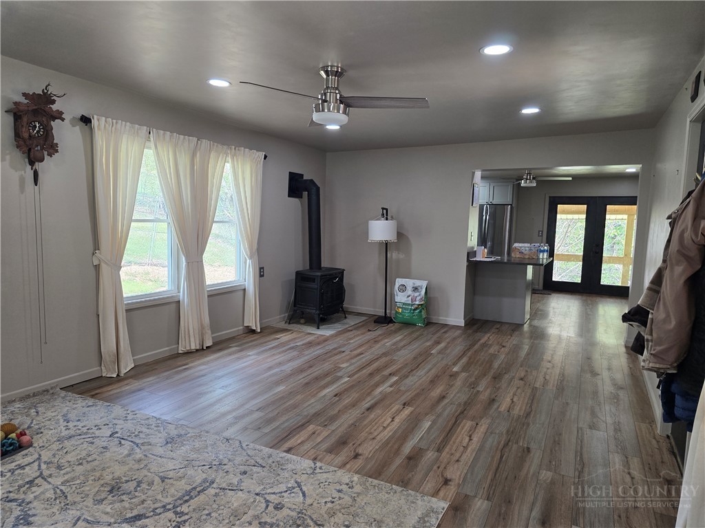 325 Sawyers Road Warrensville, NC 28693 - Photo 25 of 39 a view of empty room with wooden floor and fan