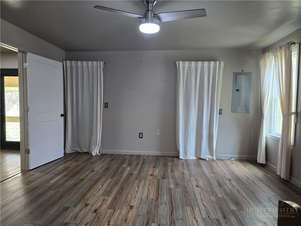 325 Sawyers Road Warrensville, NC 28693 - Photo 27 of 39 an empty room with wooden floor and a window