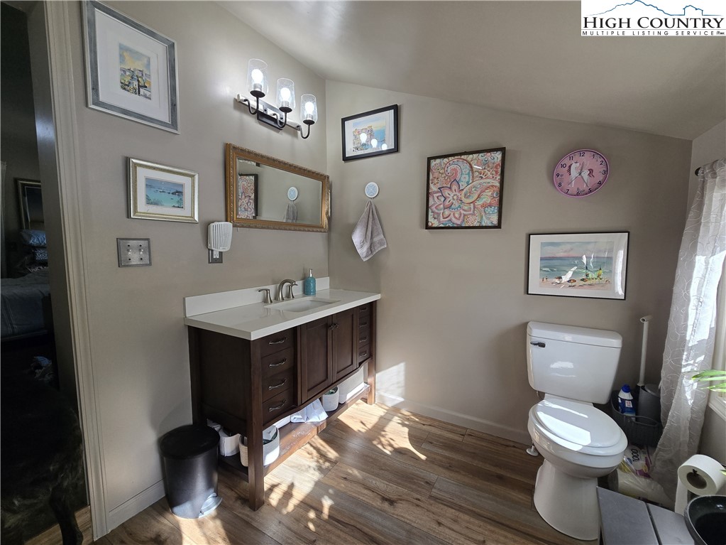 325 Sawyers Road Warrensville, NC 28693 - Photo 30 of 39 a bathroom with a toilet sink and mirror