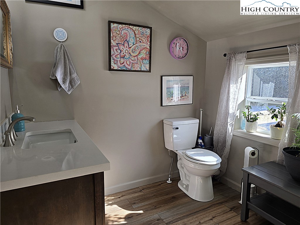 325 Sawyers Road Warrensville, NC 28693 - Photo 31 of 39 a bathroom with a toilet a sink and a window