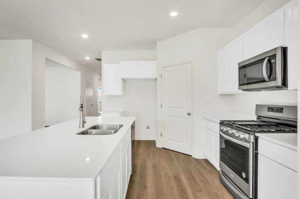 25504 West Veranium Drive Plainfield, IL 60544 - Photo 14 of 22 a kitchen that has a microwave a stove and white cabinets
