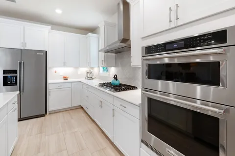 a bedroom with a bed and flat screen tv