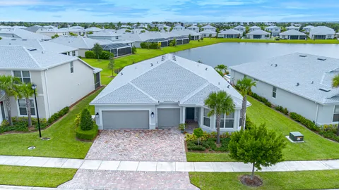 an aerial view of a house with a garden and lake view