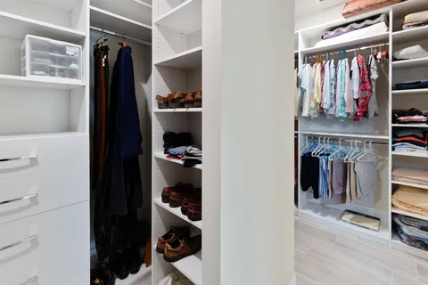 a spacious bathroom with a granite countertop sink mirror and shower