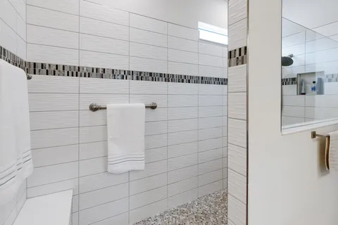 a bathroom with double vanity sinks a vanity a lamp and a mirror