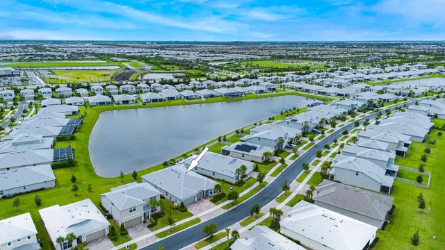 a view of a sign board with a park table and chairs