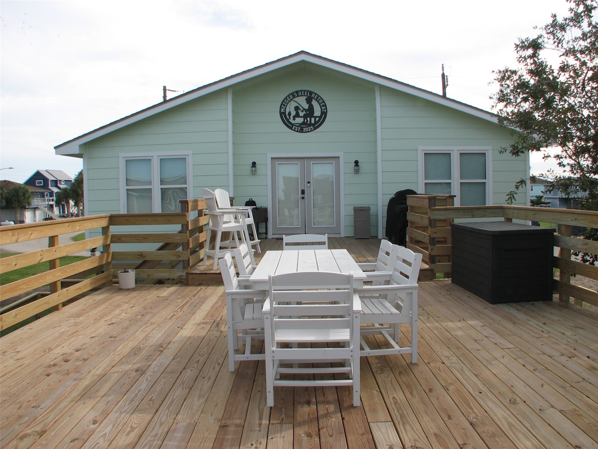 a view of a house with wooden deck and furniture