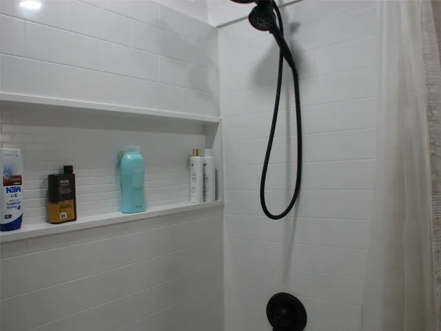 a bathroom with a bath tub and a shower