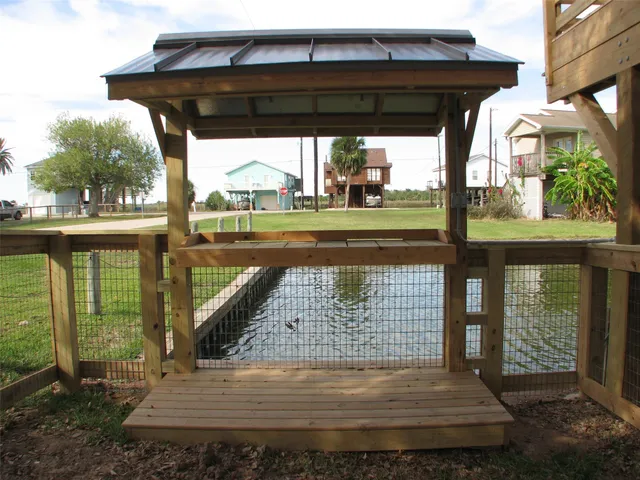 a view of a porch with a floor to ceiling window next to a yard