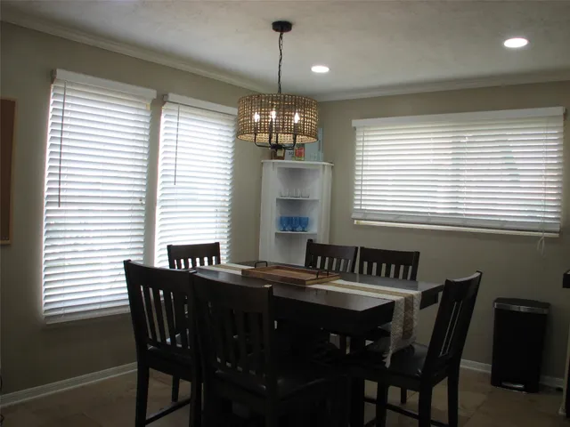 a view of a dining room with furniture and window