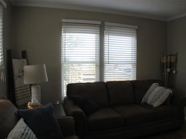 a living room with furniture and a lamp
