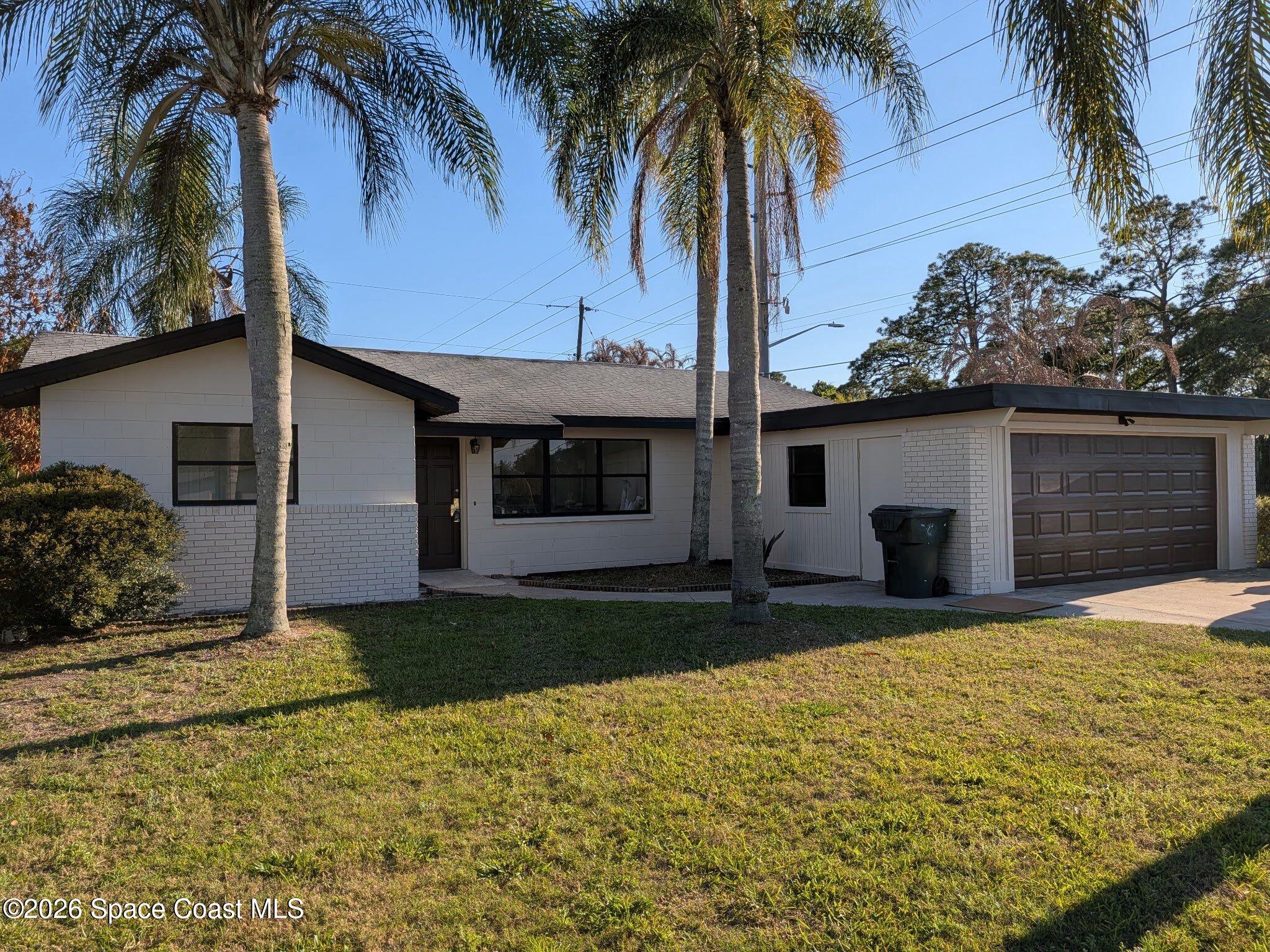 999 Cardon Drive Rockledge, FL 32955 - Photo 1 of 8 a front view of house with yard and porch