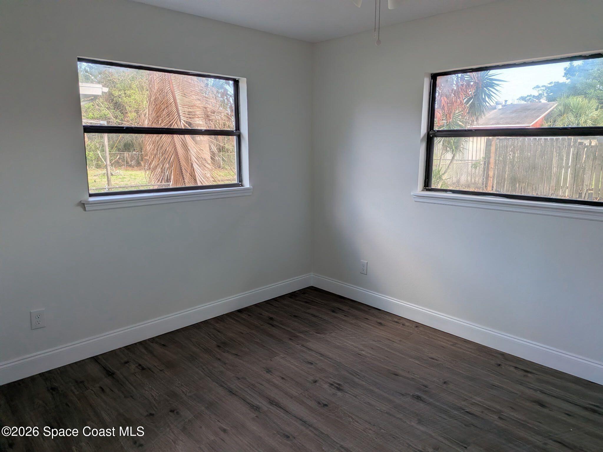 999 Cardon Drive Rockledge, FL 32955 - Photo 6 of 8 a view of an empty room with wooden floor and a window