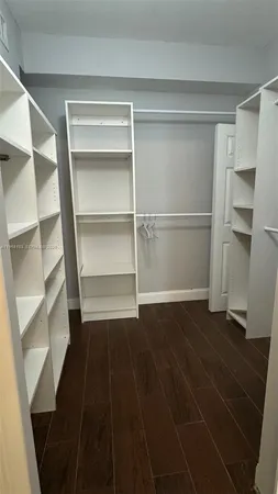 a view of walk in closet with empty racks